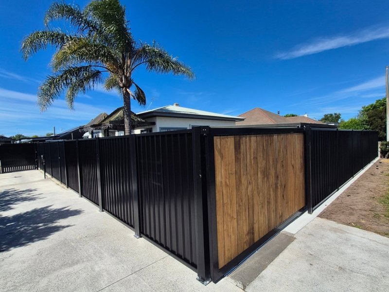 Black fence with timber feature gate